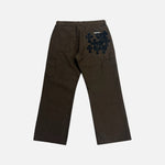 Load image into Gallery viewer, Chrome Hearts carpenter trousers in brown with a leather cross patch on the rear pocket