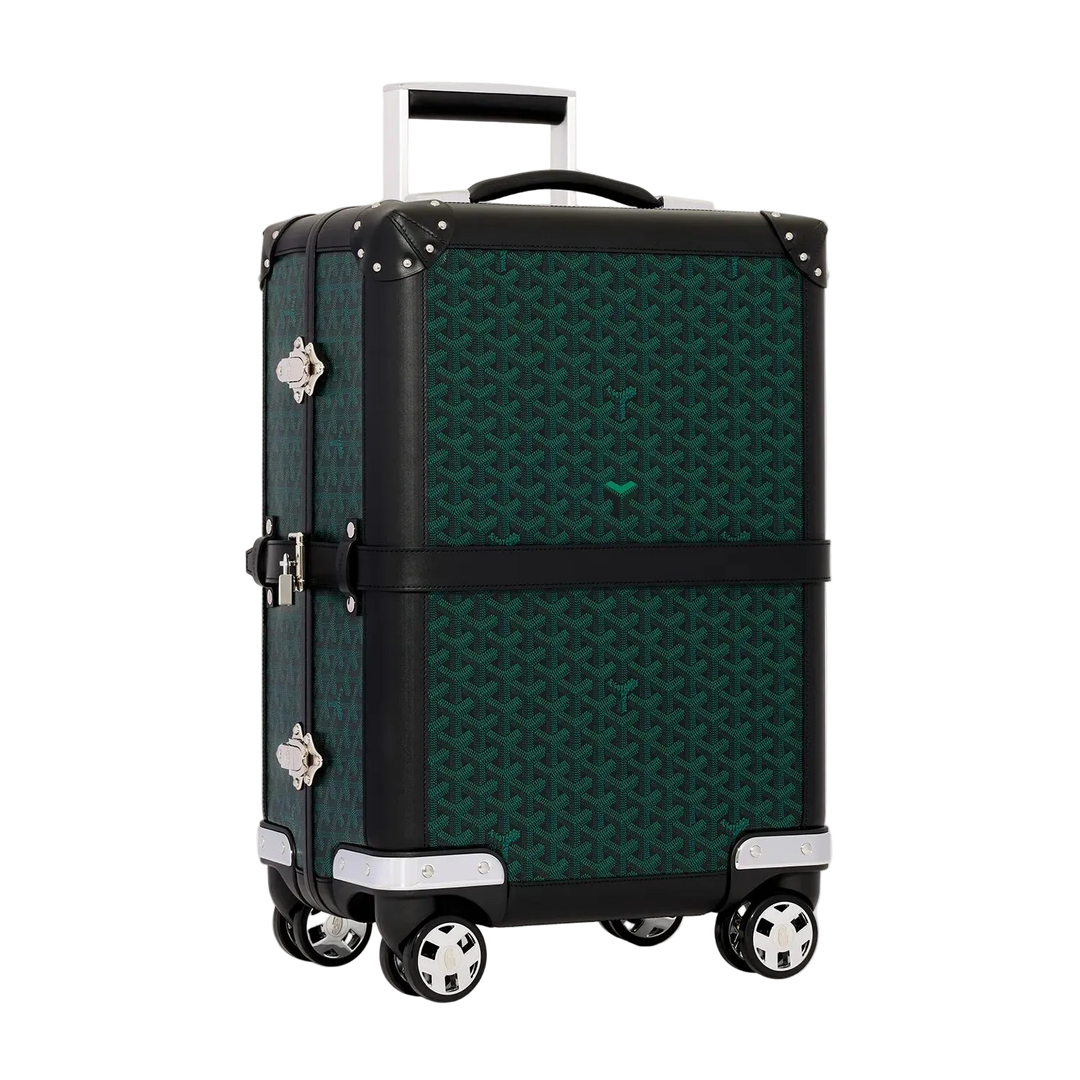 A Goyard 70cm square spinner suitcase in their signature Goyardine pattern, featuring a dark green and black geometric print, black trim, silver-tone hardware, and an extended telescoping handle, set against a solid off-white background.
