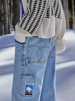 Load image into Gallery viewer, Chanel Coco Neige Carpenter Jeans in Light Blue Denim, styled in the snow