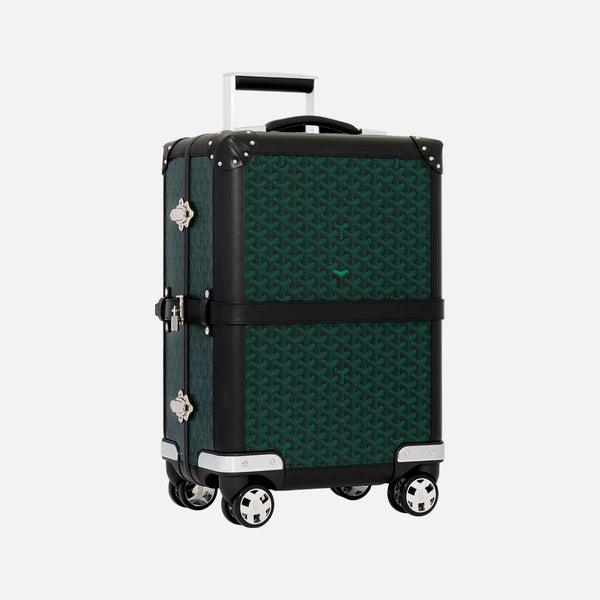 A Goyard 70cm square spinner suitcase in their signature Goyardine pattern, featuring a dark green and black geometric print, black trim, silver-tone hardware, and an extended telescoping handle, set against a solid off-white background.