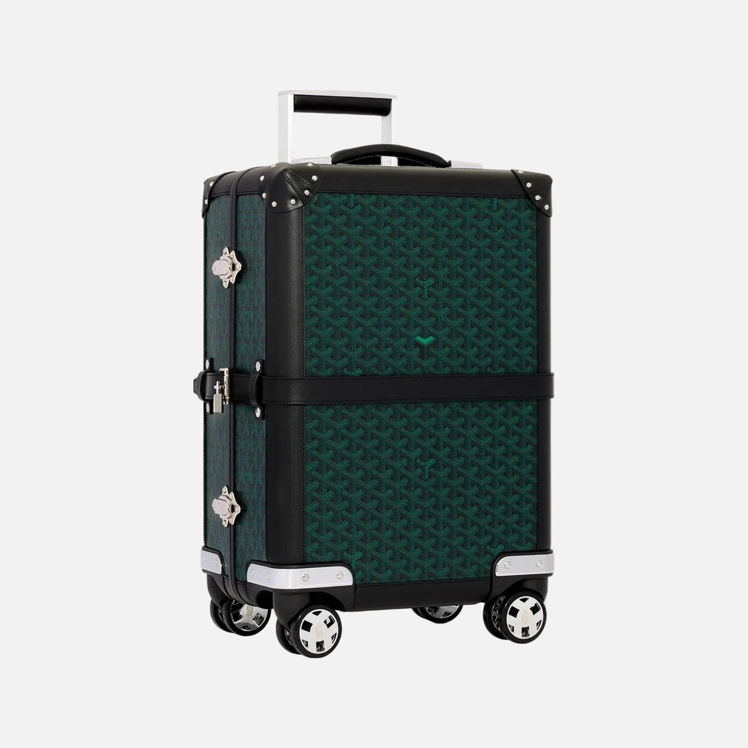 A Goyard 70cm square spinner suitcase in their signature Goyardine pattern, featuring a dark green and black geometric print, black trim, silver-tone hardware, and an extended telescoping handle, set against a solid off-white background.