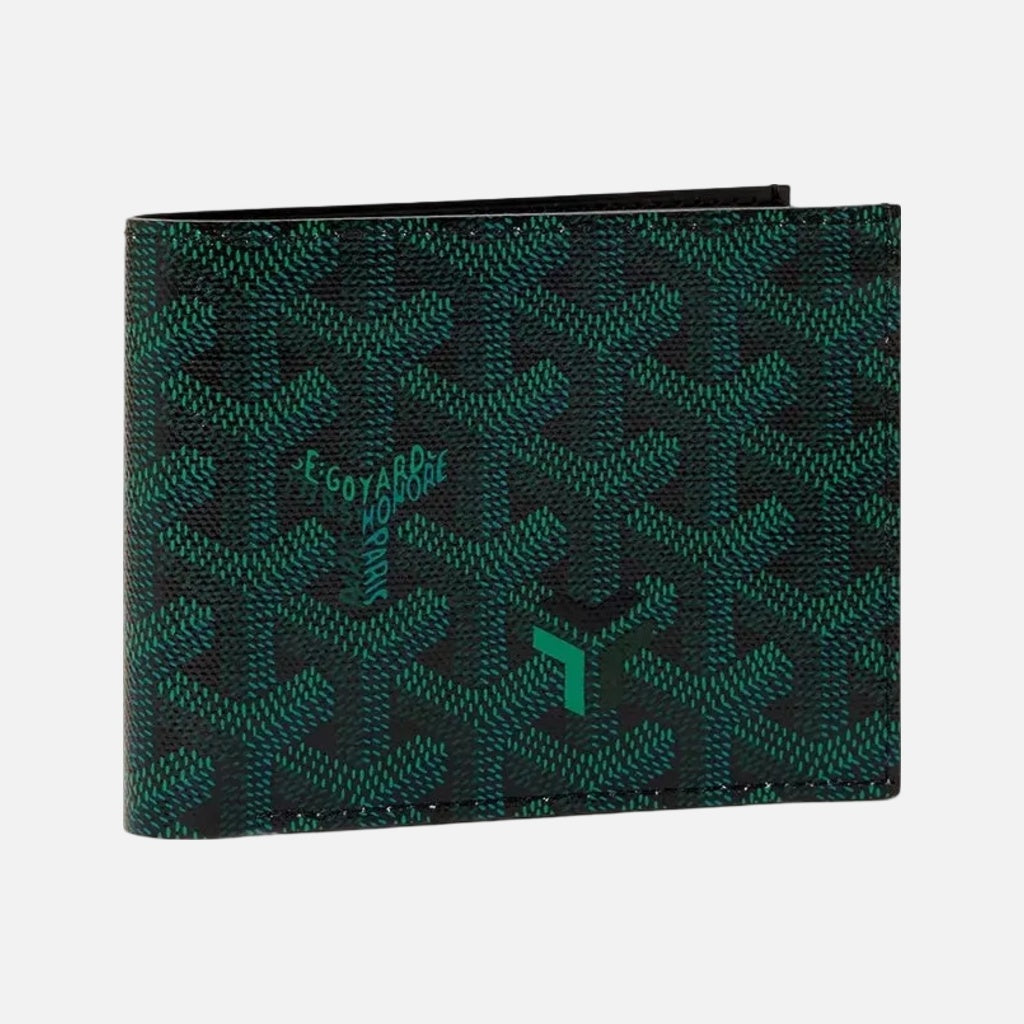 A Goyard bi-fold wallet featuring the brand's signature green and black chevron pattern, shown closed on a light cream background.