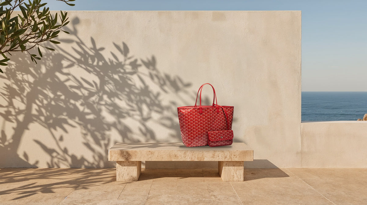 Goyard Saint Louis PM in red on a travertine bench in the sun