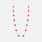 Load image into Gallery viewer, A delicate gold chain necklace featuring a series of bright pink clover-shaped beads, displayed against a clean, light gray background.