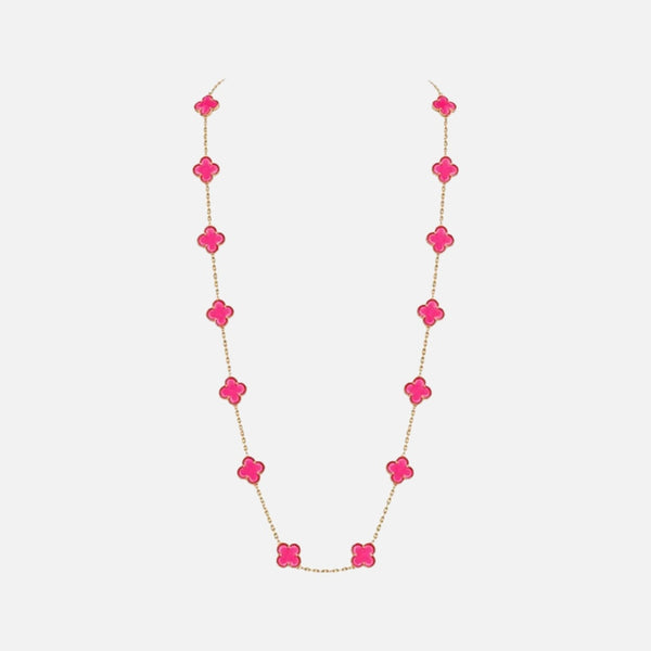 A delicate gold chain necklace featuring a series of bright pink clover-shaped beads, displayed against a clean, light gray background.