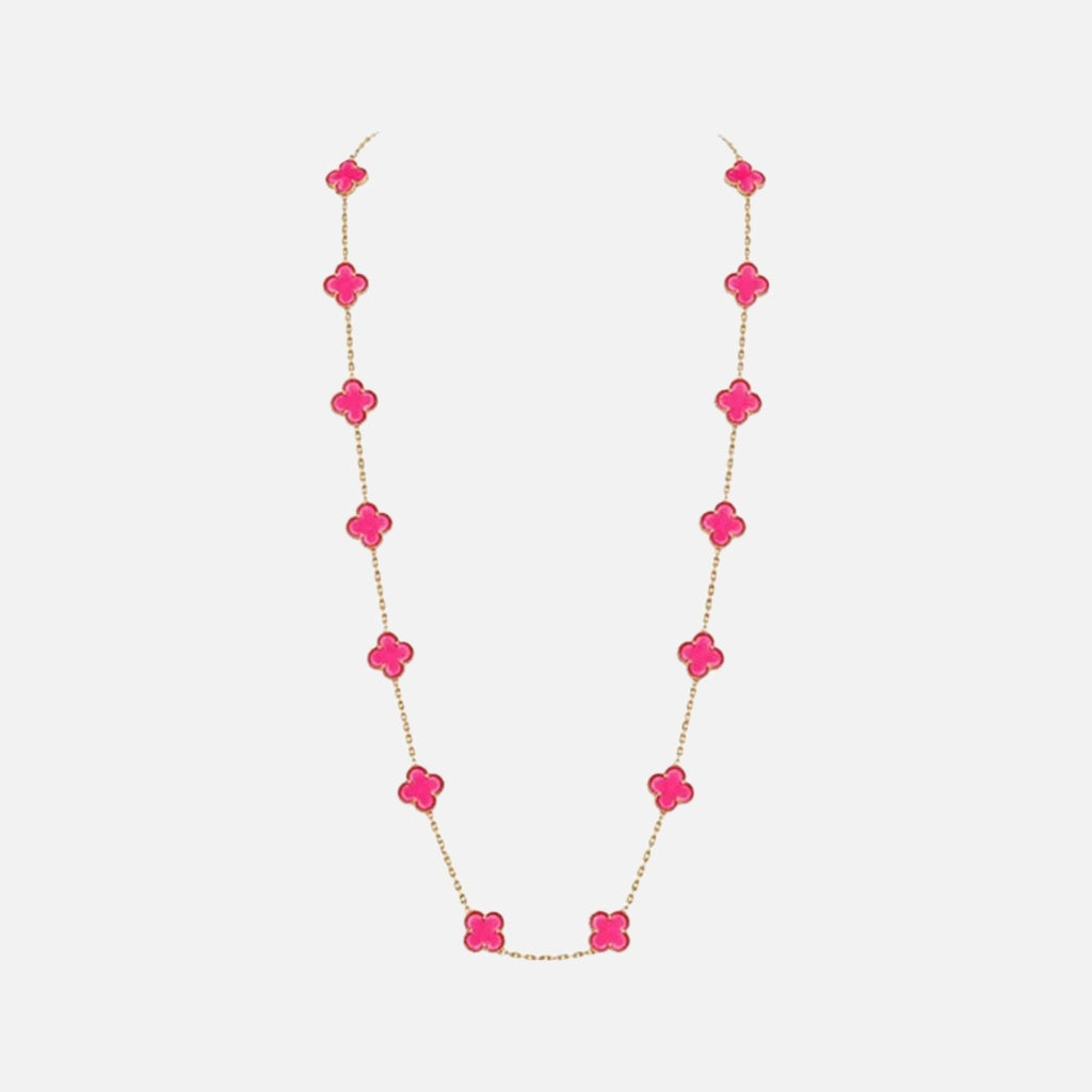 A delicate gold chain necklace featuring a series of bright pink clover-shaped beads, displayed against a clean, light gray background.