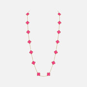 A delicate gold chain necklace featuring a series of bright pink clover-shaped beads, displayed against a clean, light gray background.