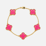 Load image into Gallery viewer, A gold chain bracelet featuring five bright pink clover-shaped charms, each outlined with a textured gold border, displayed on a clean white background.